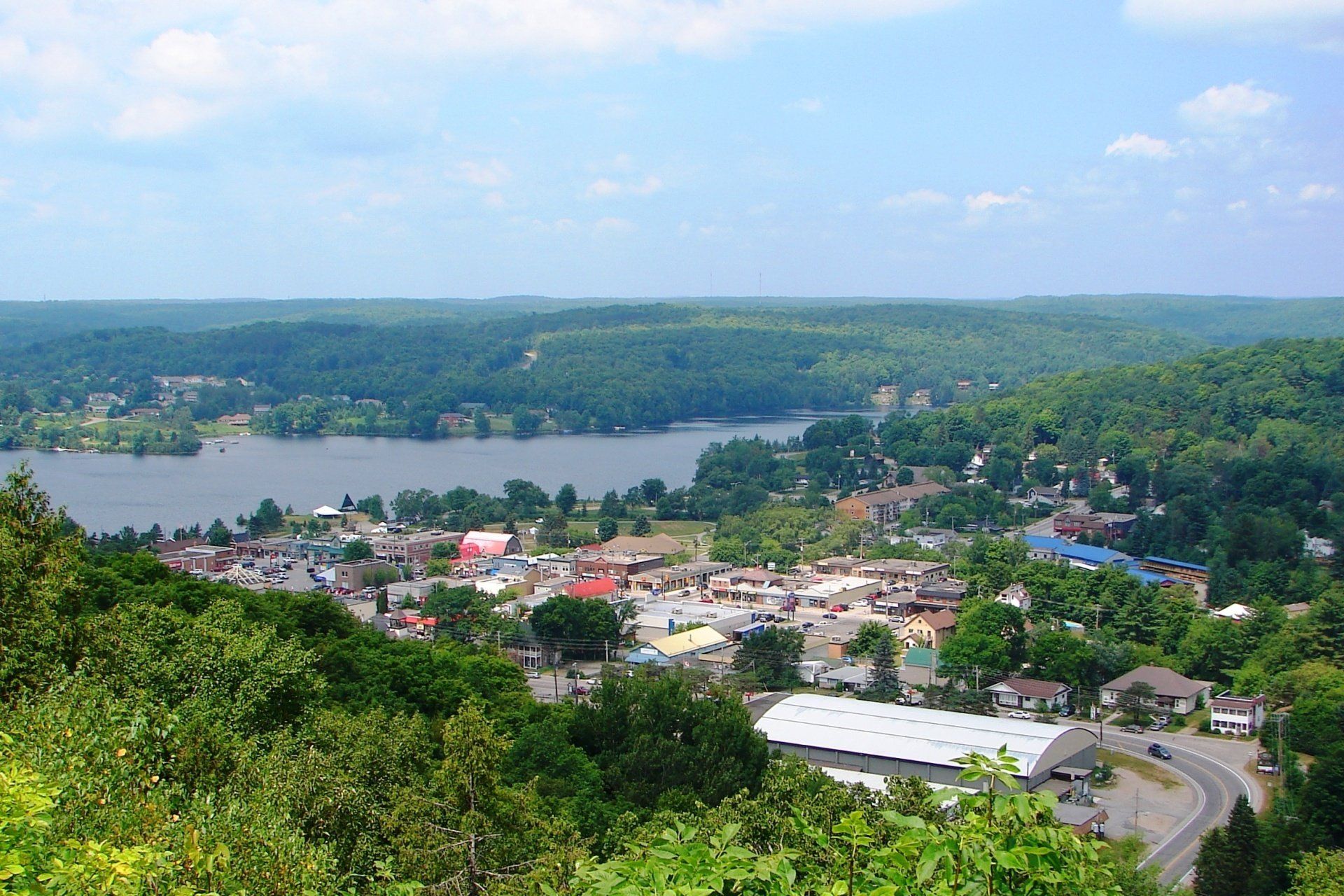 An aerial view of a small town with a lake in the background