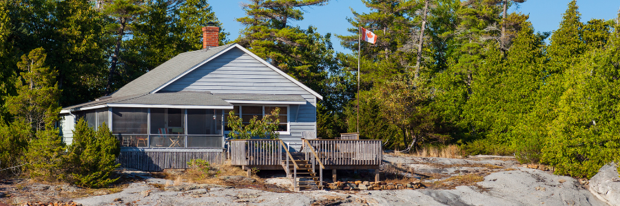 A small house is sitting next to a piece of paper that says land tax.