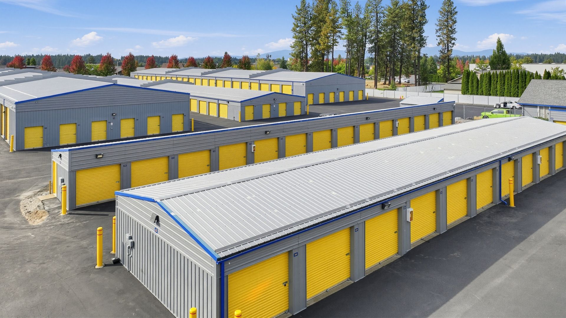 Various sizes of outdoor drive-up storage units in Pendleton at Airport Rd with yellow roll-up doors and a wide drive aisle