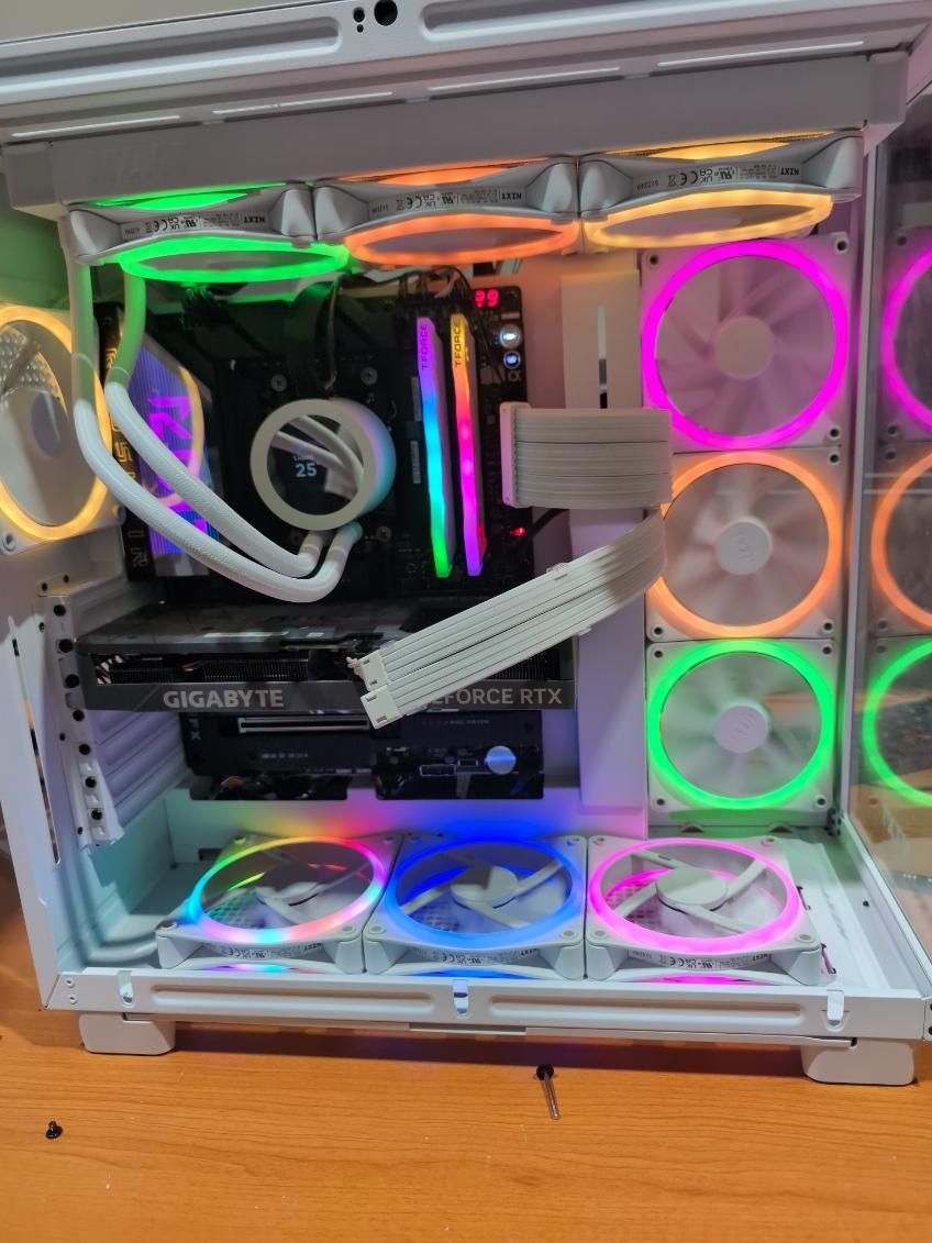 Open white PC case with colorful RGB fans and components inside