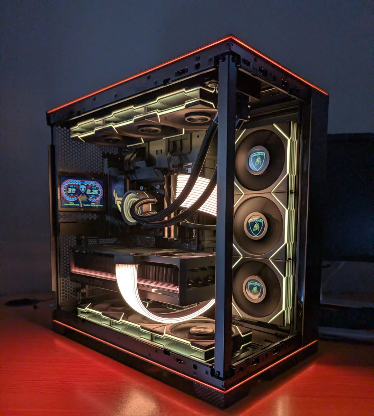 Custom RGB-lit gaming PC in a transparent case with glowing red, white, and blue accents
