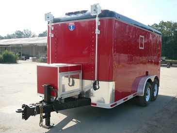 a red trailer is parked in a parking lot