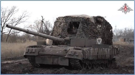 A military tank is sitting in the dirt in a field.