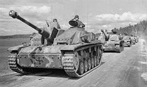A black and white photo of a row of tanks driving down a road.