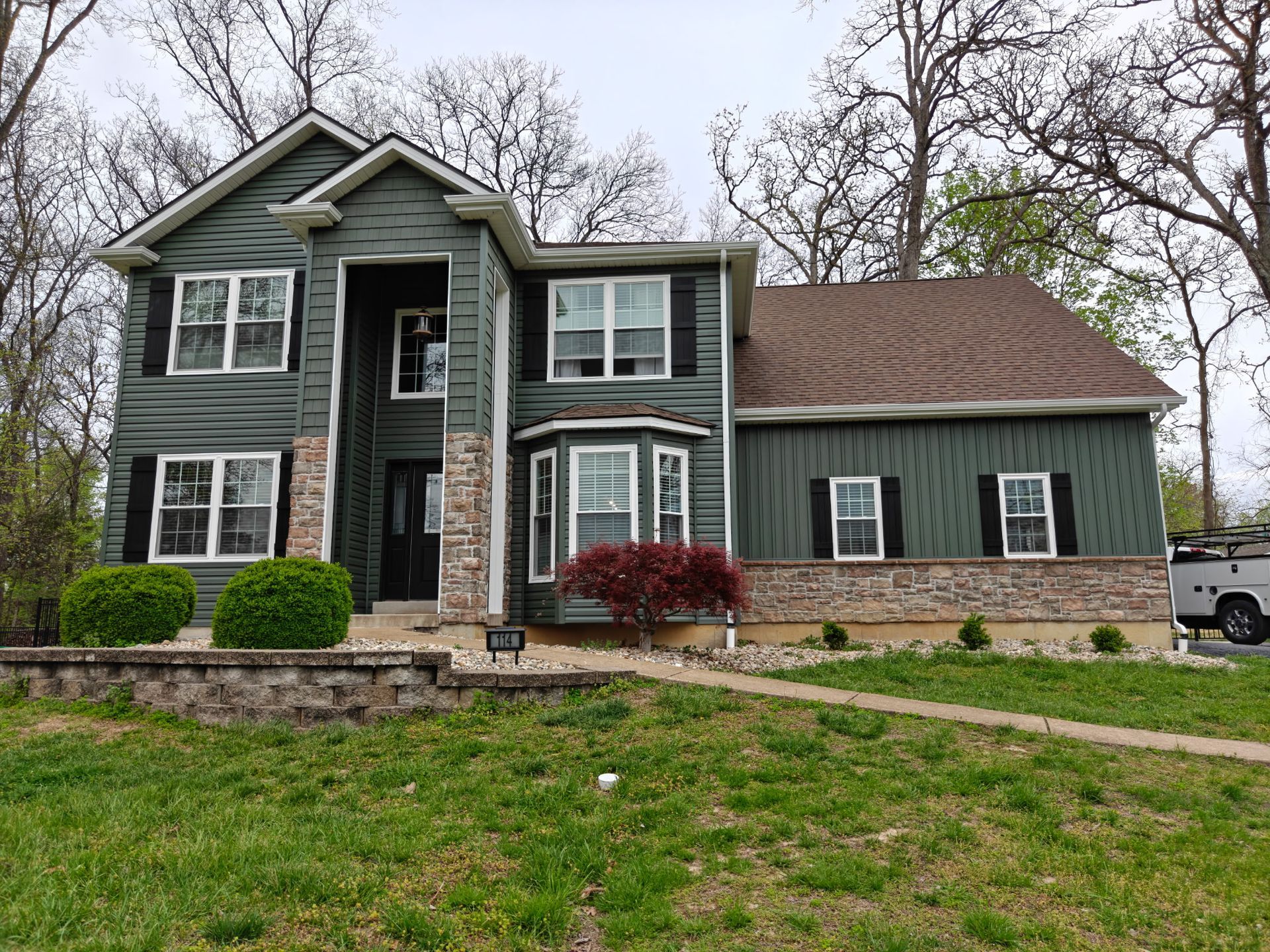Green Spruce Siding Of A House — St. Peters, MO — Home Comfort Exteriors Green Spruce Siding Of A House — St. Peters, MO — Home Comfort Exteriors