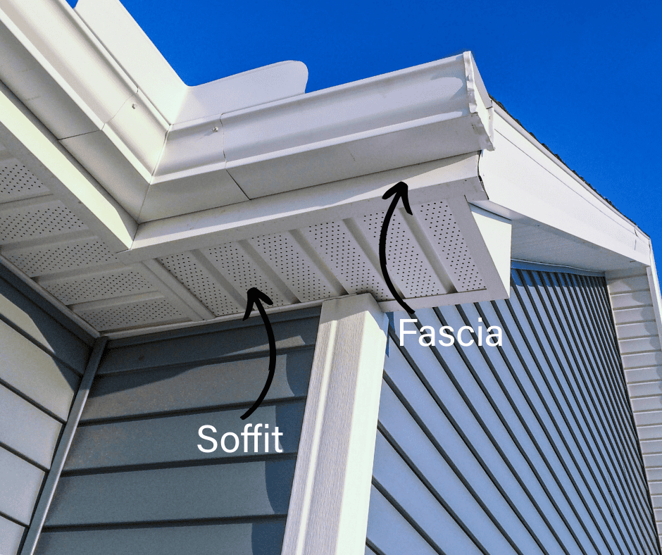 Anatomy of a residential roofline featuring labeled white vinyl soffit, fascia trim, and seamless gutters in St. Charles County.
