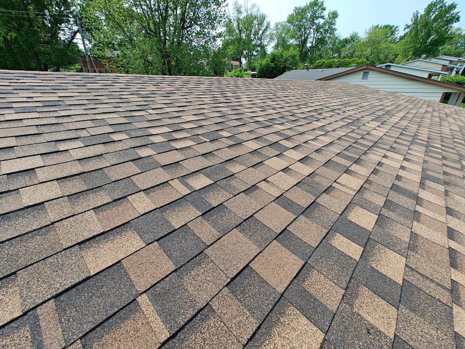 IKO Dynasty architectural shingles on a roof in the color Shadow Brown.