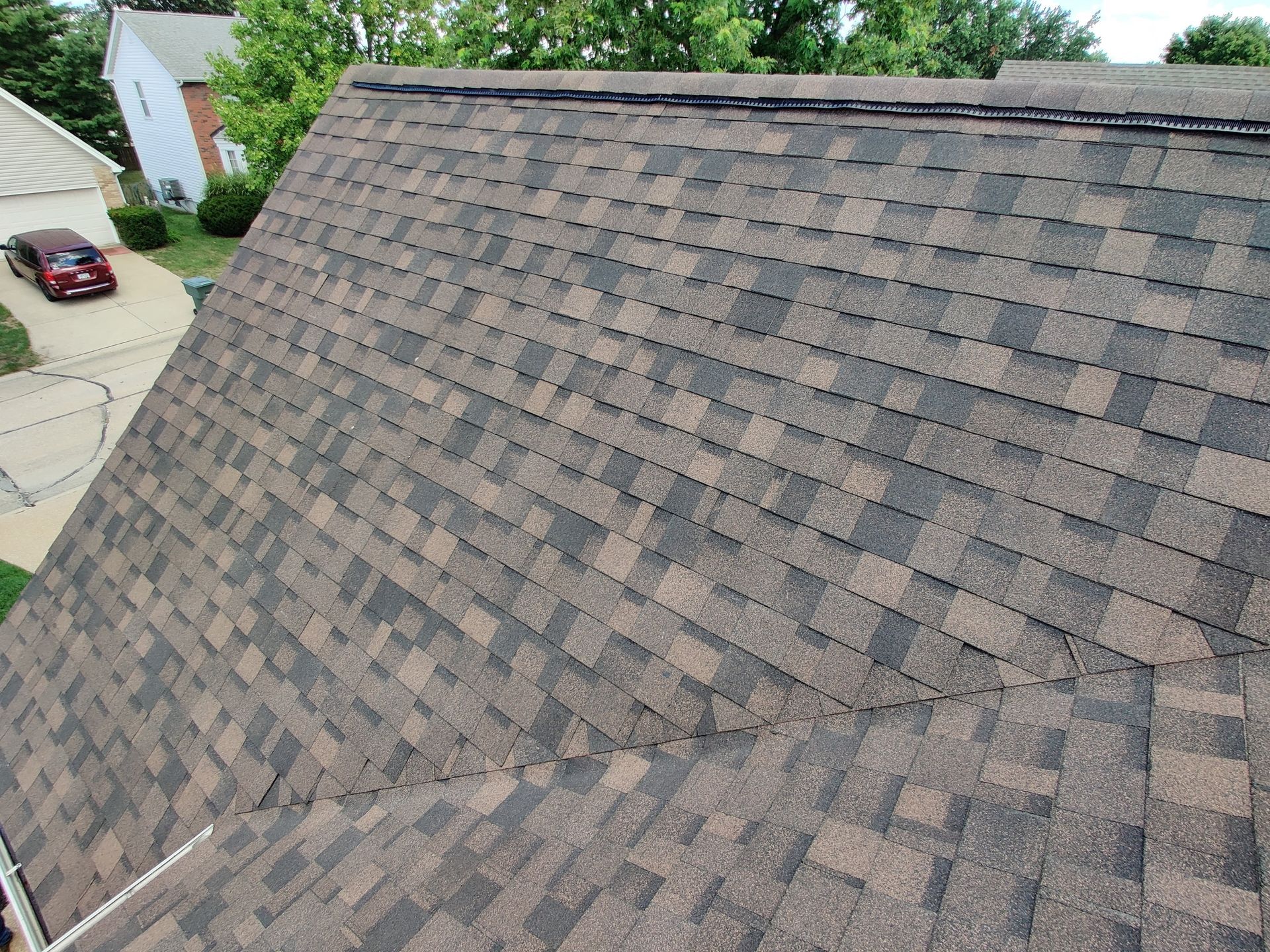 IKO Dynasty architectural shingles on a roof in the color Shadow Brown.