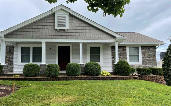 Exterior home remodel showing premium Affinity Stone accents, vinyl siding, and custom cedar shake gable shingles in St. Charles County.