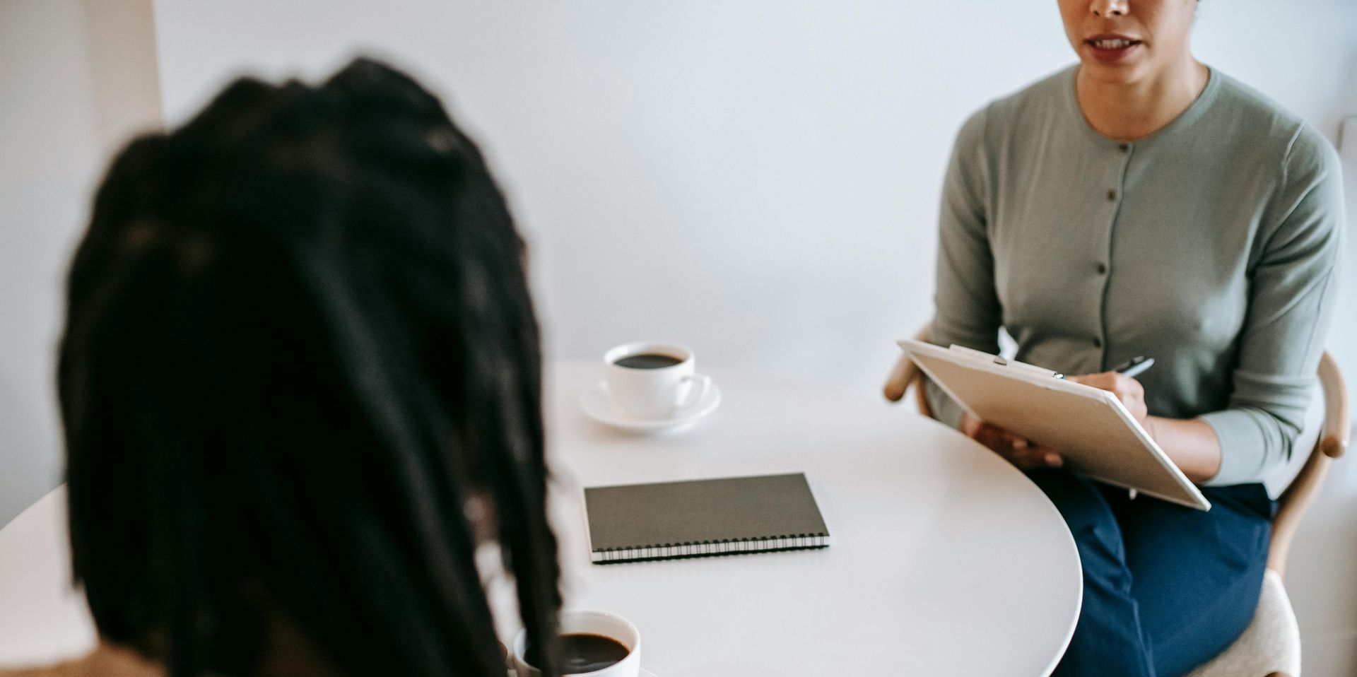 People in meeting with a woman taking notes