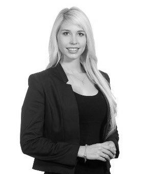 A black and white photo of a woman in a black jacket.