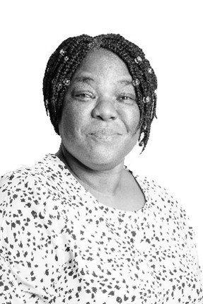 A black and white photo of a woman wearing a polka dot shirt.