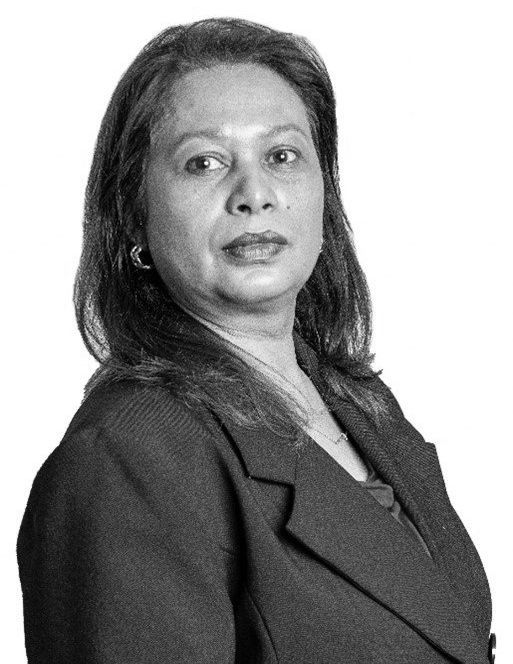 A black and white photo of a woman in a suit