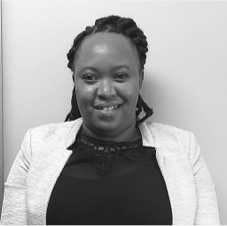 A black and white photo of a woman wearing a white jacket and a black shirt.