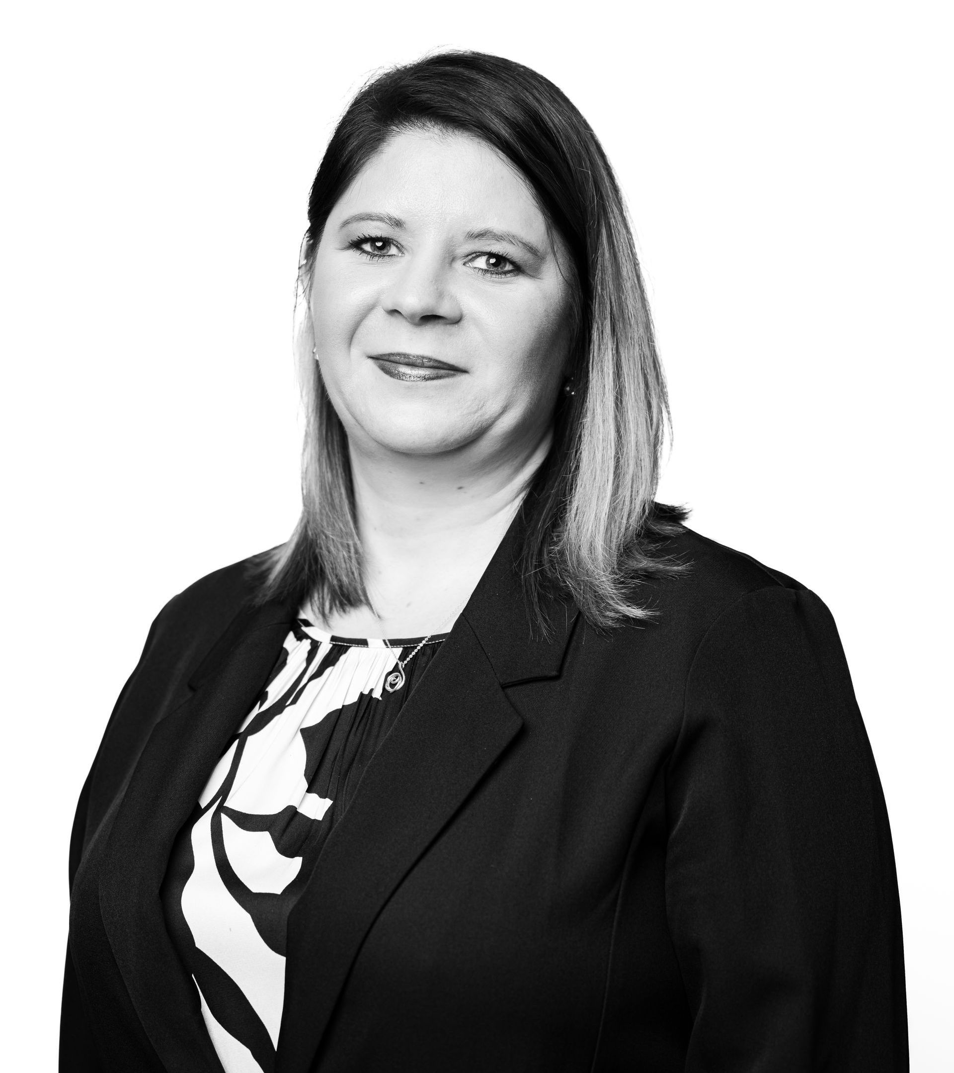 A black and white photo of a woman in a suit