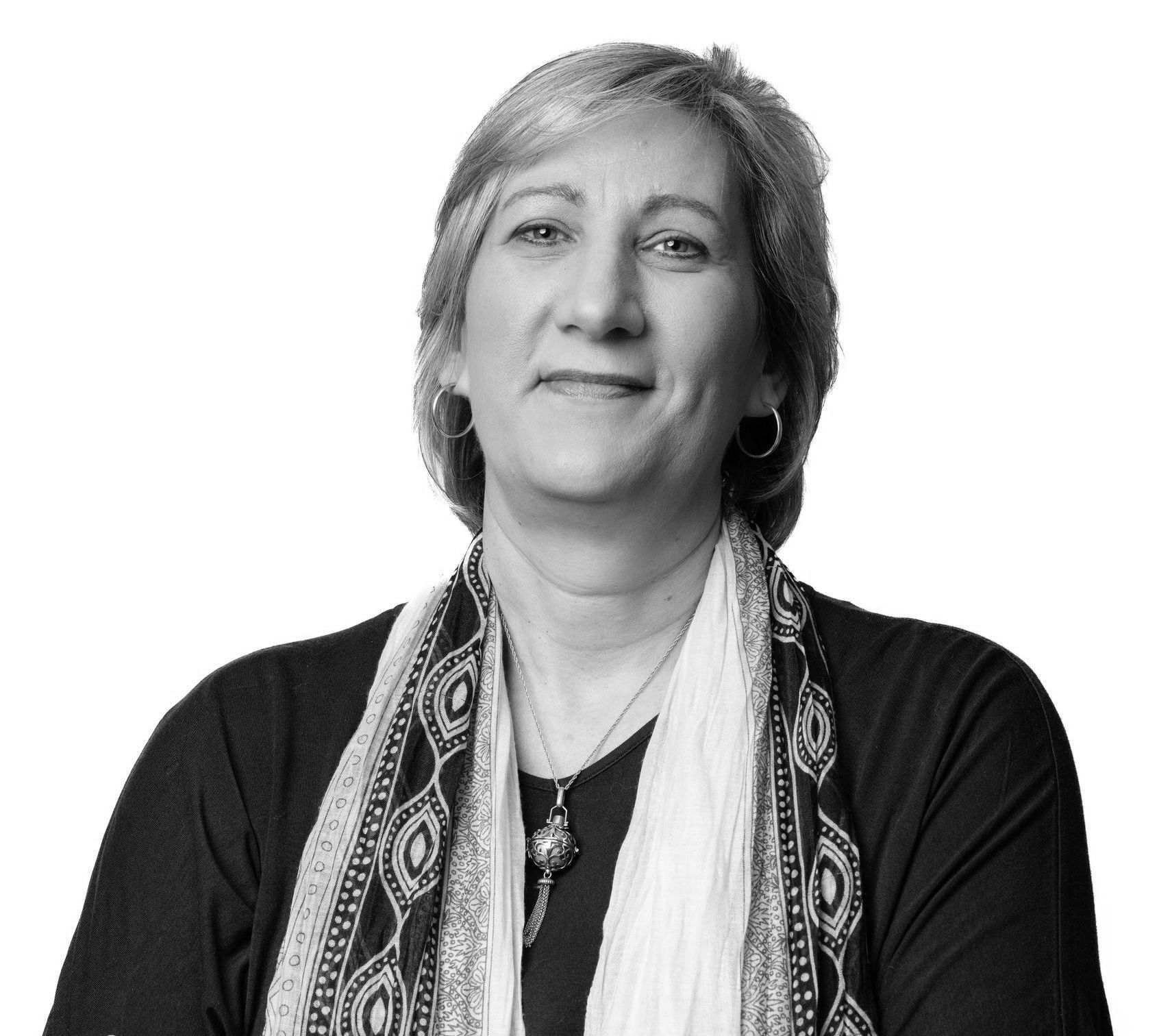 A black and white photo of a woman wearing a scarf
