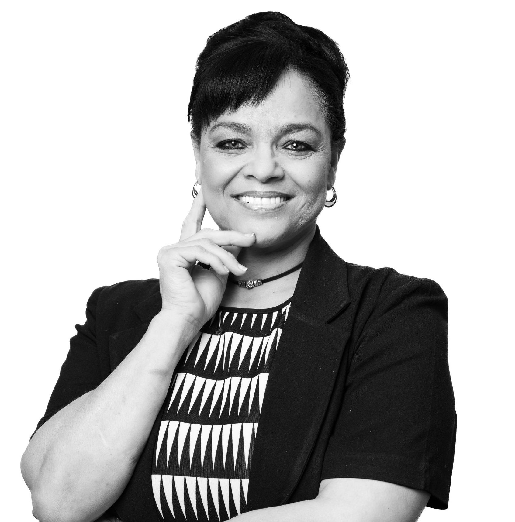 A woman in a black and white photo with her hand on her chin