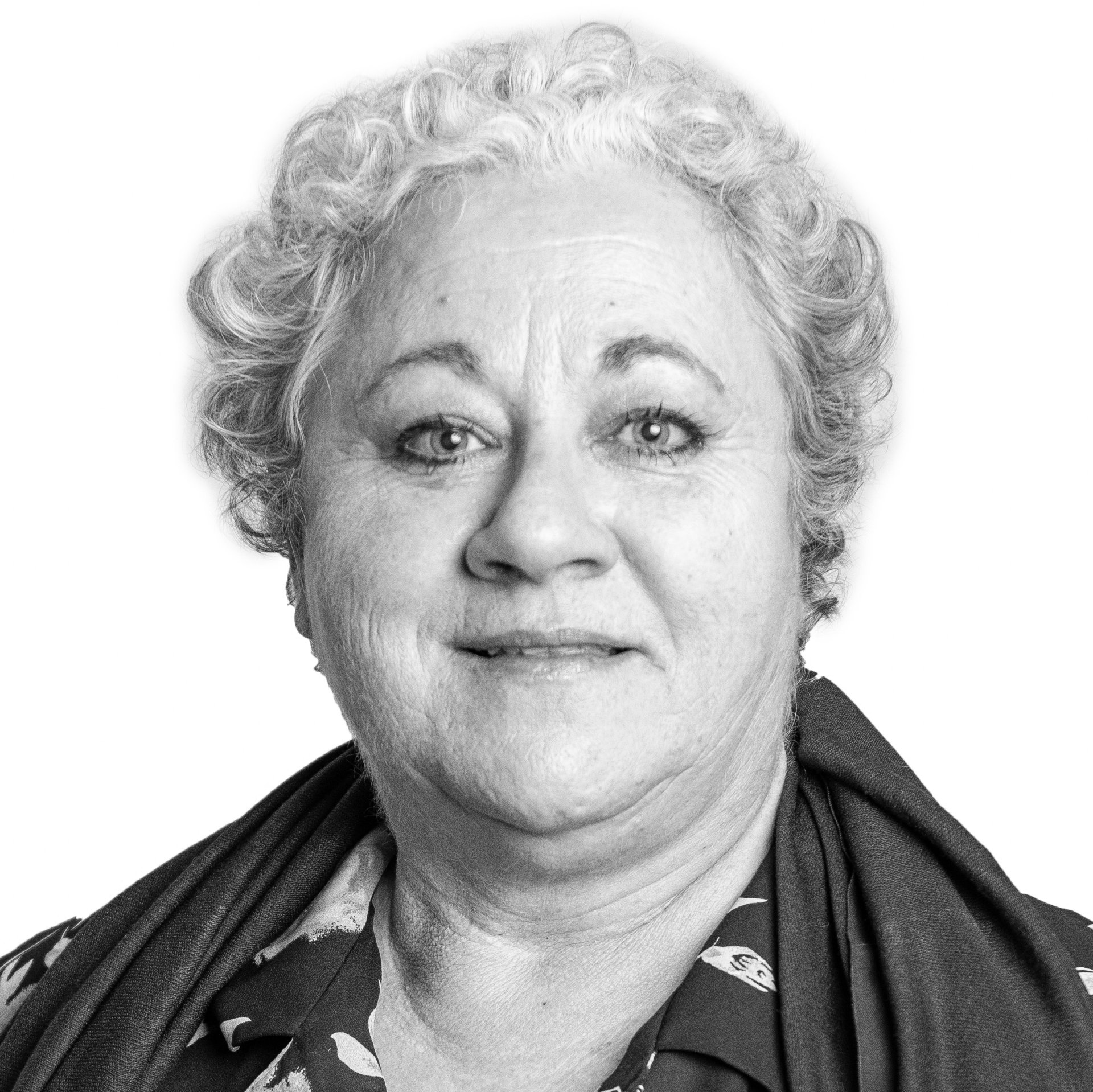 A black and white photo of a woman with curly hair and a scarf around her neck.