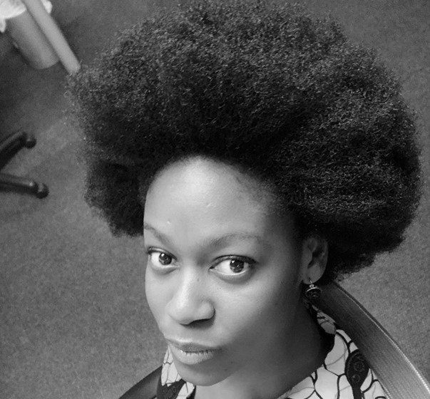 A black and white photo of a woman with an afro