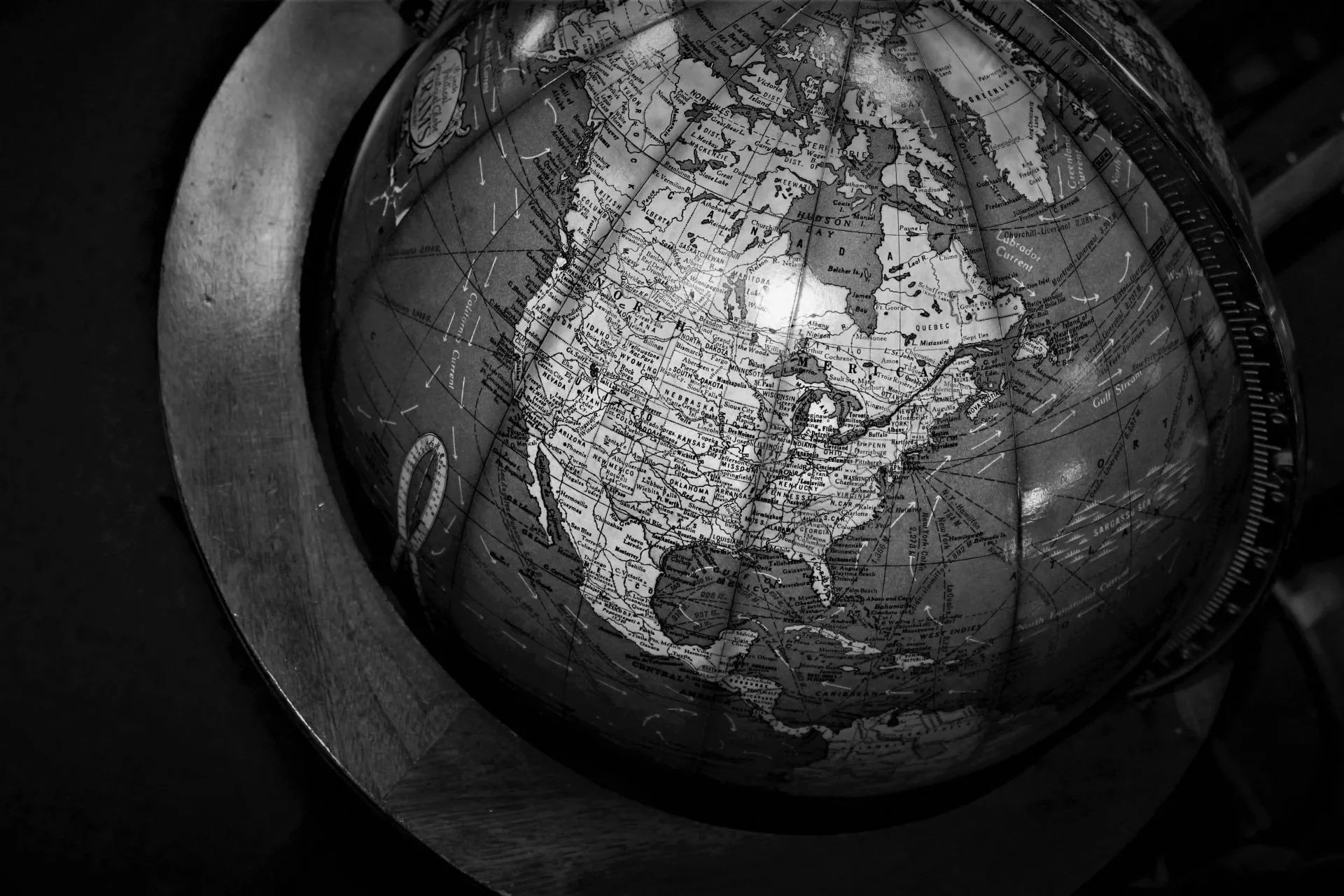 A black and white photo of a globe showing the united states of america.