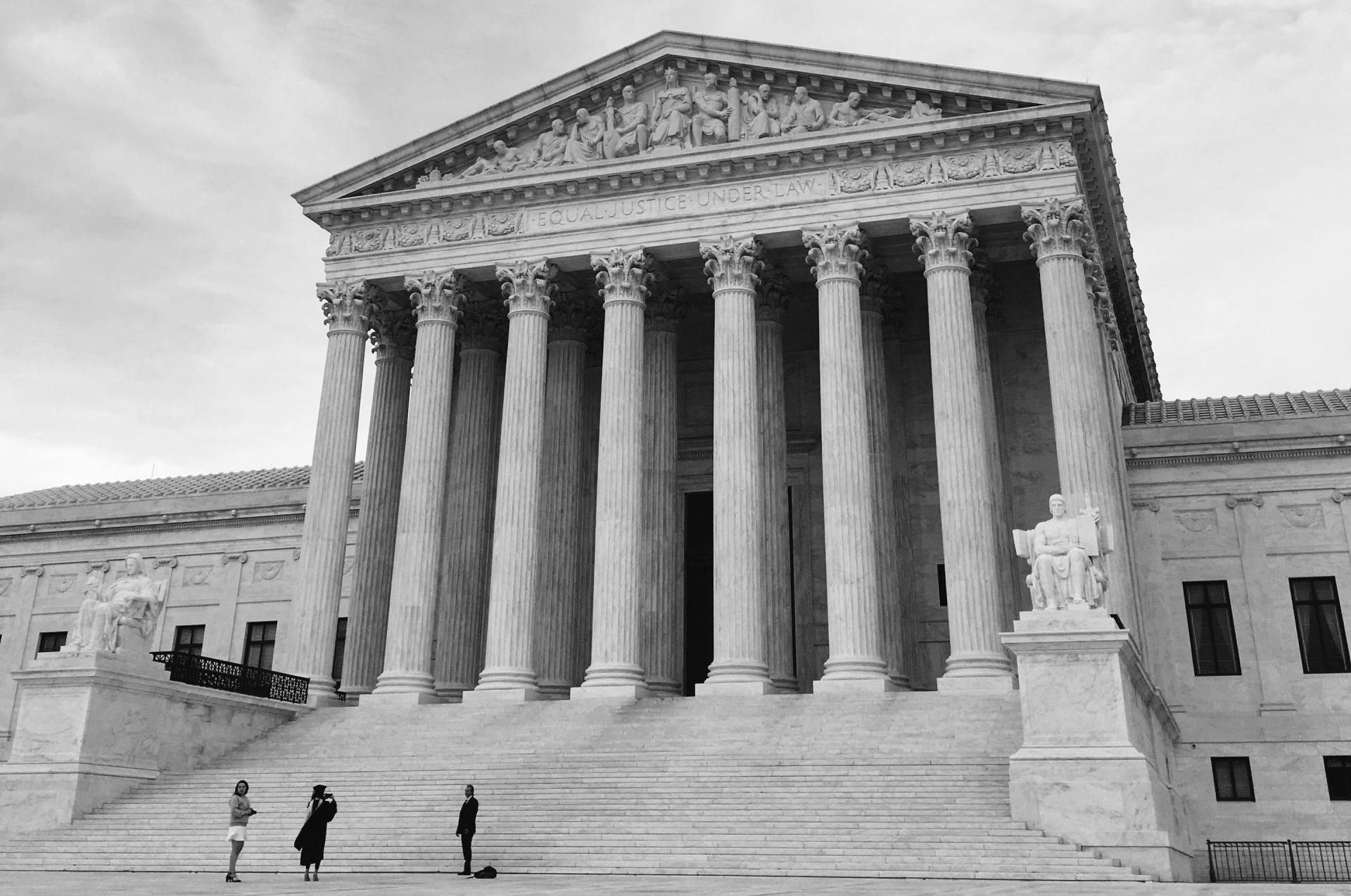 A black and white photo of the supreme court building