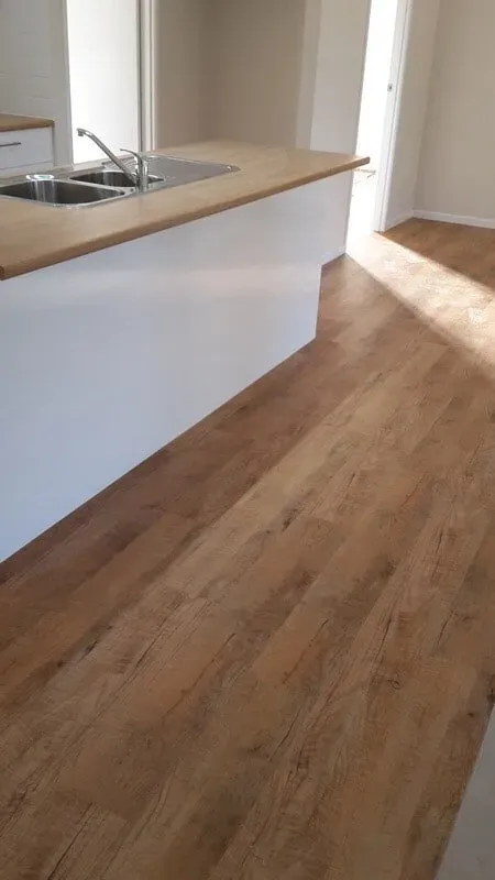 A Kitchen With a Sink and a Wooden Floor — Aussie Carpets & Vinyl In Beerwah, QLD