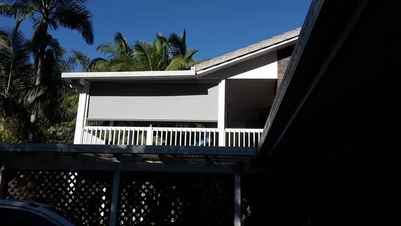 A Car is Parked in Front of a House With a Balcony — Aussie Carpets & Vinyl In Beerwah, QLD