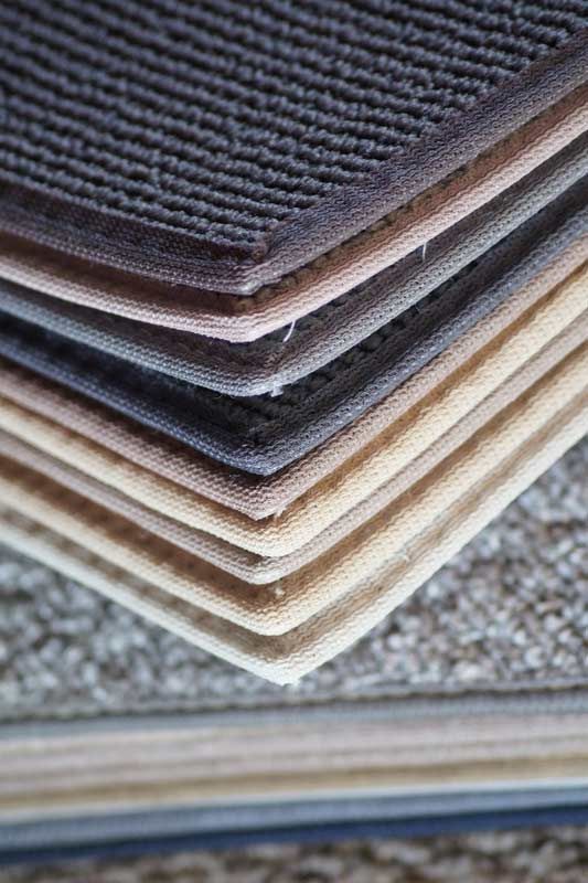 A Close Up of a Stack of Carpets in Different Colors — Aussie Carpets & Vinyl In Beerwah, QLD