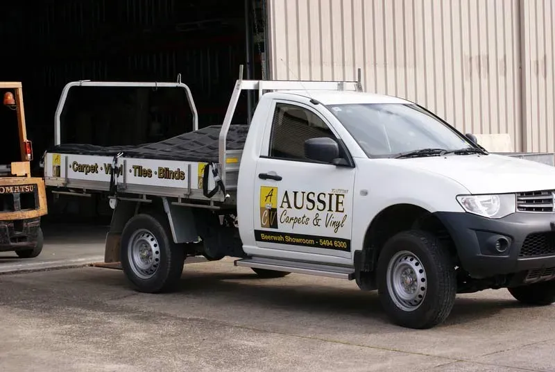 A White Truck With the Word Aussie on It — Aussie Carpets & Vinyl In Beerwah, QLD