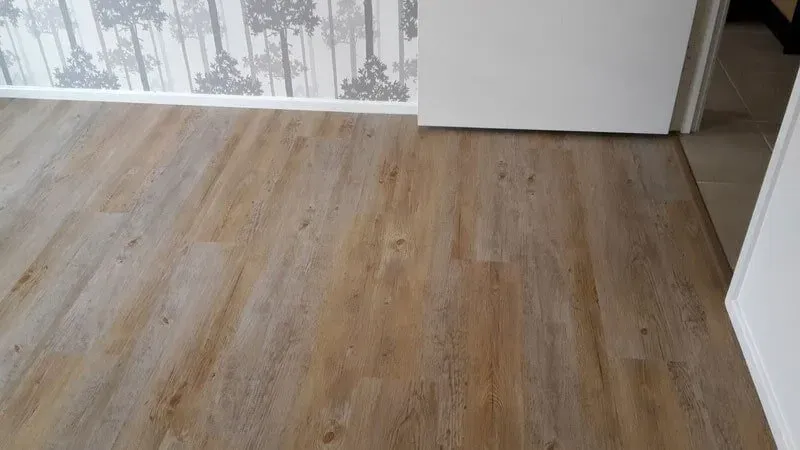 A Wooden Floor in a Room Next to a Door — Aussie Carpets & Vinyl In Beerwah, QLD