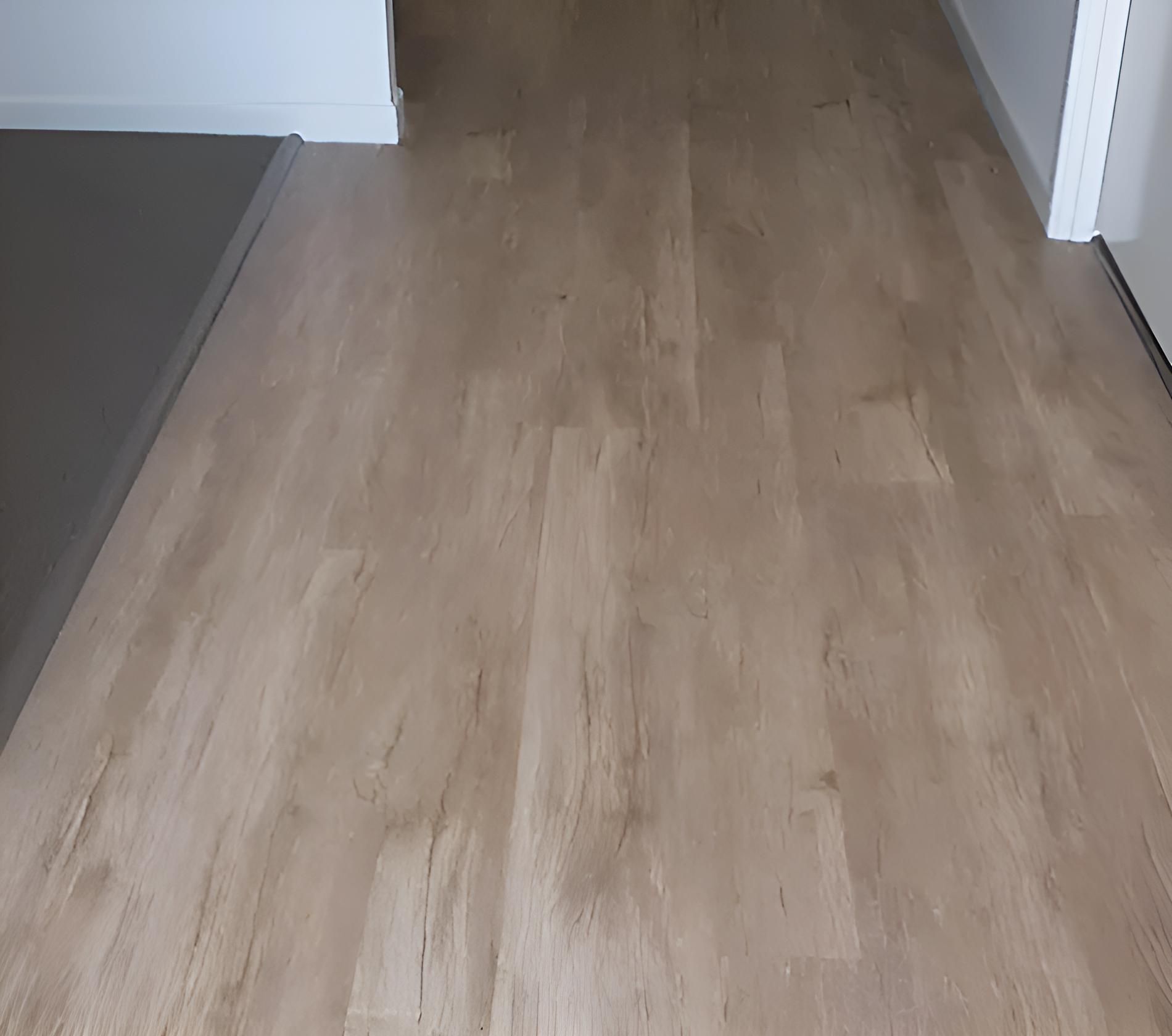 A Wooden Floor in a Hallway Next to a Door — Aussie Carpets & Vinyl In Beerwah, QLD