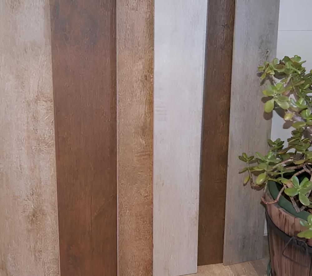 A Potted Plant is Sitting Next to a Row of Wooden Boards — Aussie Carpets & Vinyl In Beerwah, QLD
