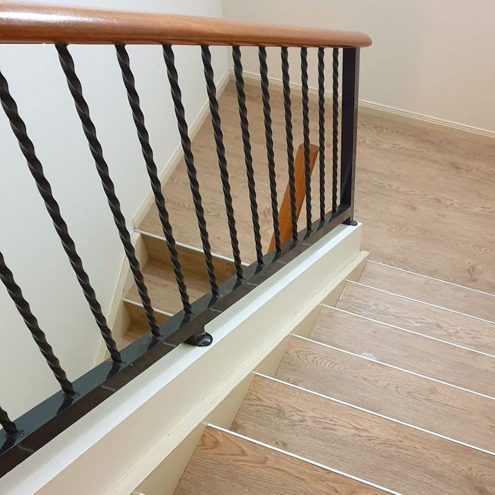 A Staircase With a Black Railing and Wooden Handrail — Aussie Carpets & Vinyl In Beerwah, QLD