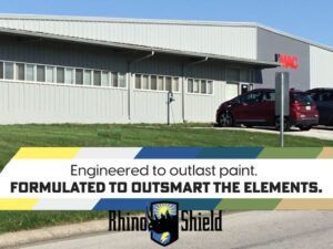 Commercial building with a Rhino Shield ad banner and a red SUV parked outside