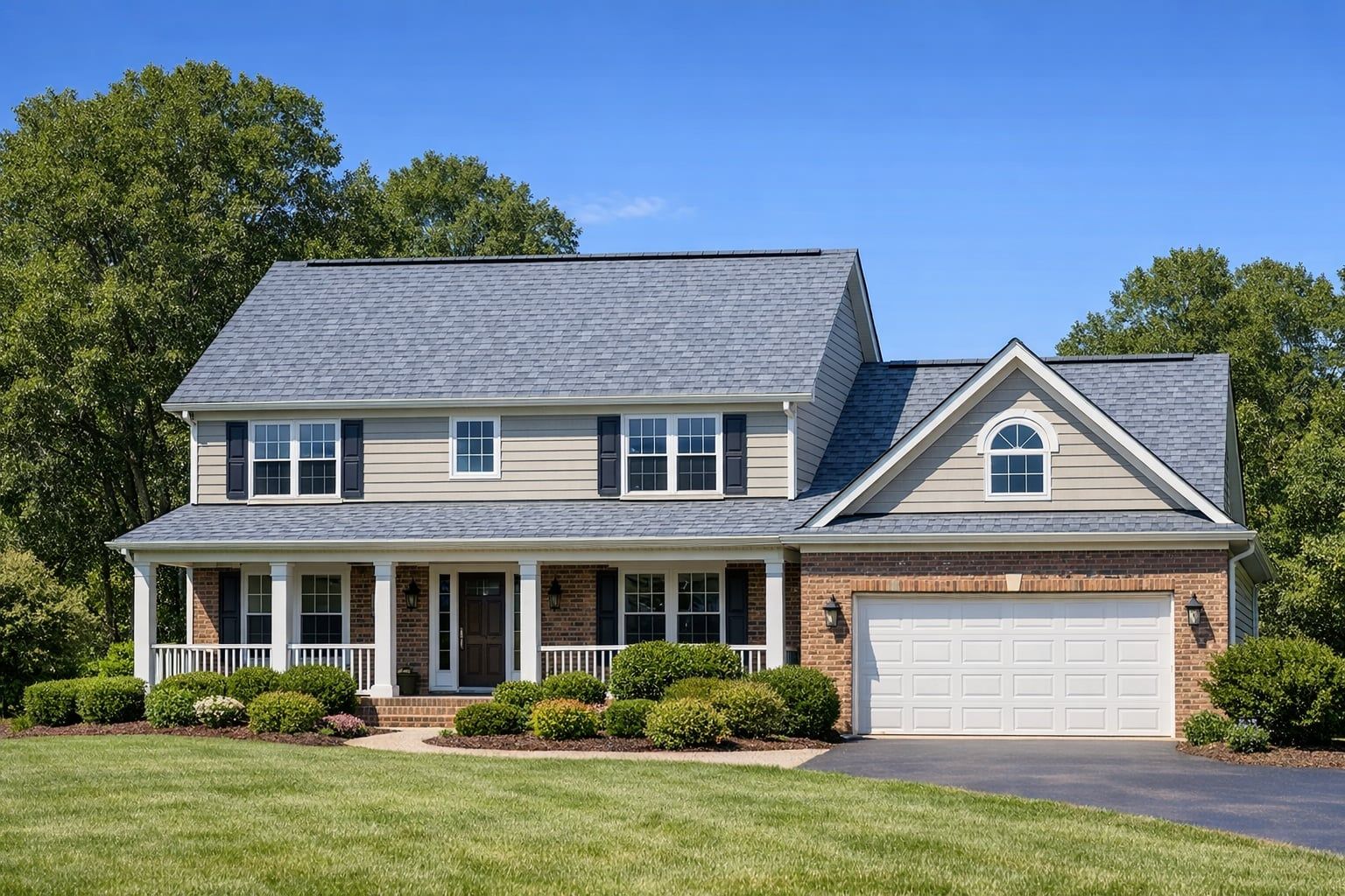 Two story Virginia home with a new light gray architectural shingle roof and ridge vent on a sunny day