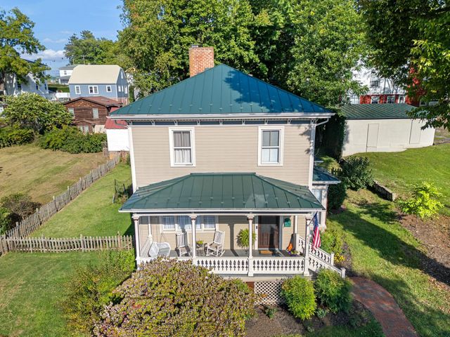 Green metal roof on a historic two-story home in Staunton, VA