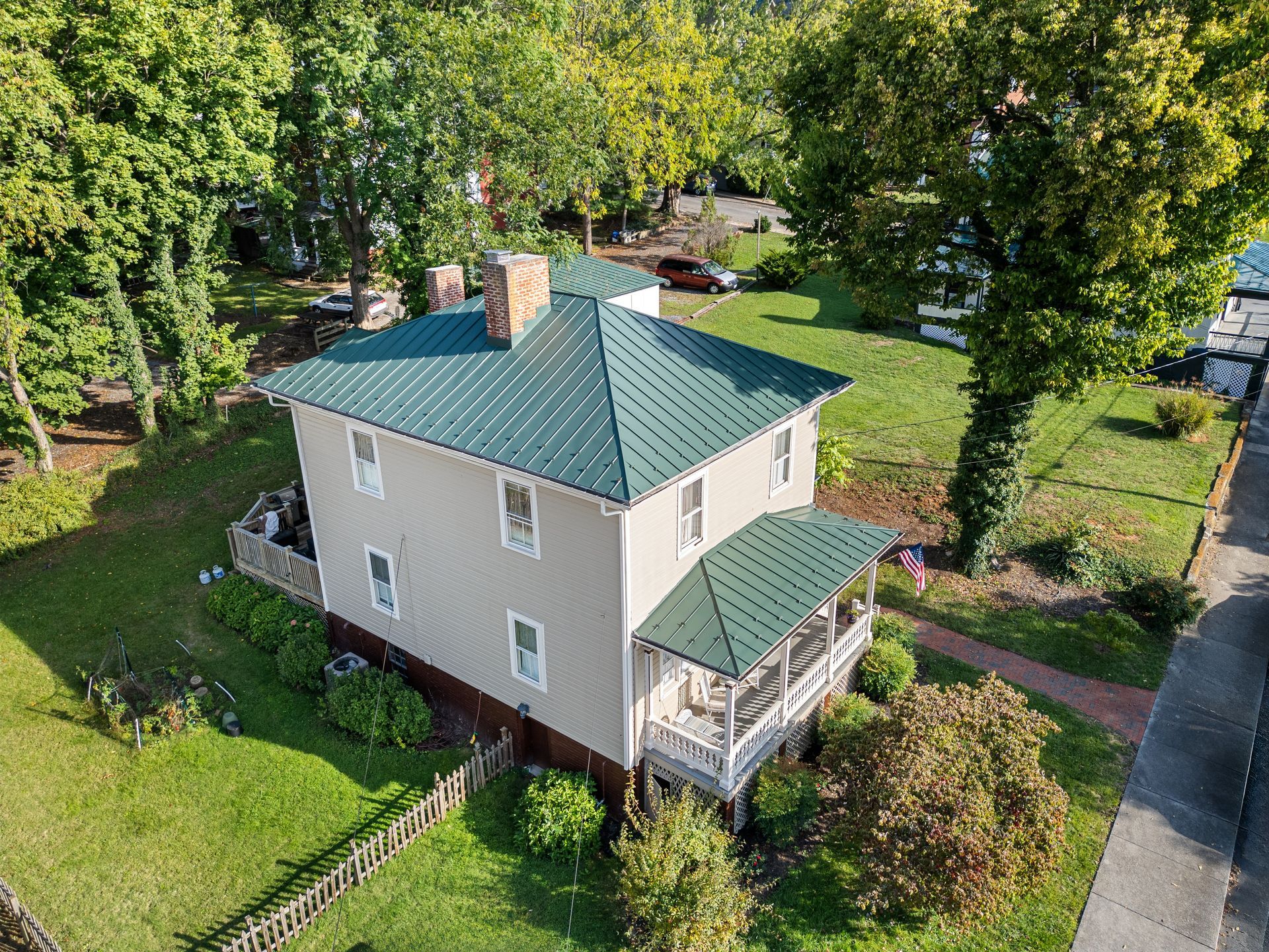 Farmhouse with a standing seam metal roof over house and porch