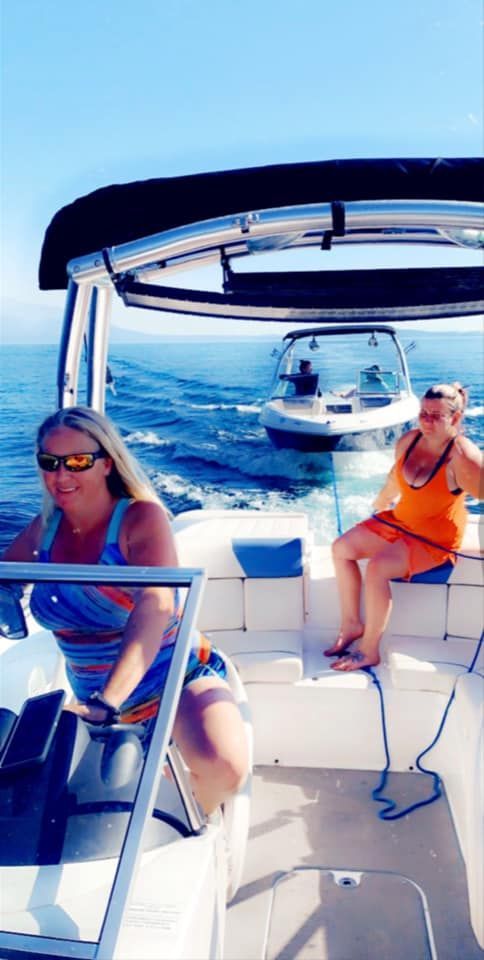 Two women are sitting on a boat in the ocean.