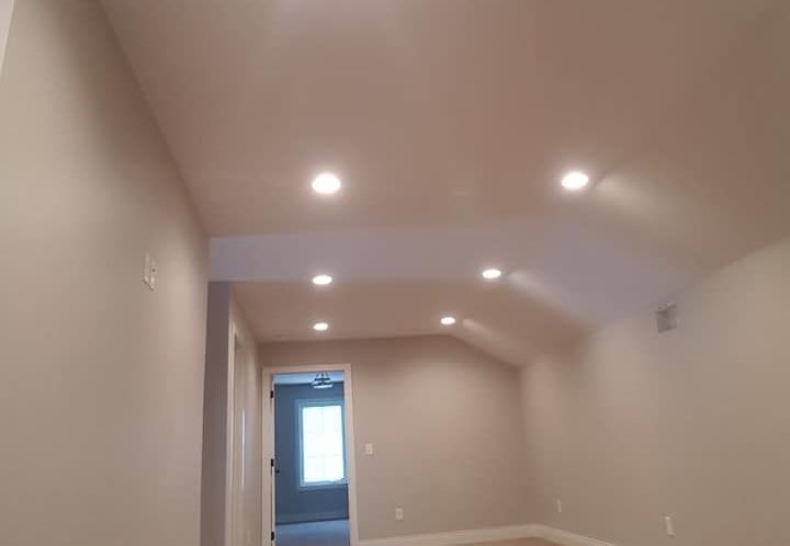 residential home with an angled ceiling that has new drywall and paint