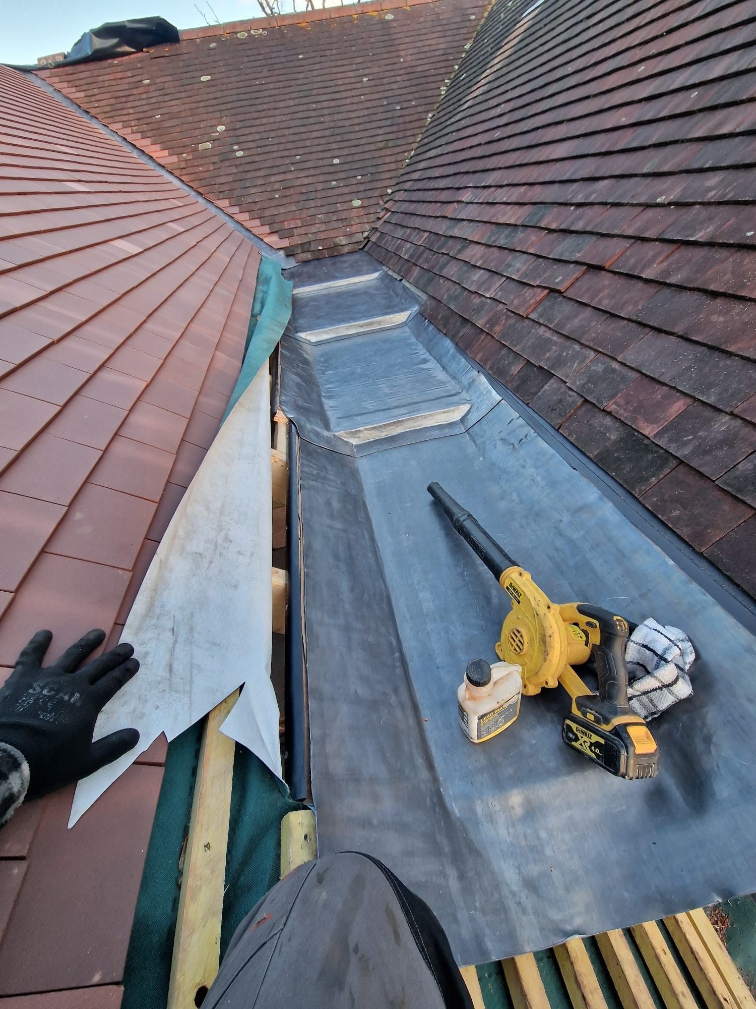 A person is working on the roof of a building.
