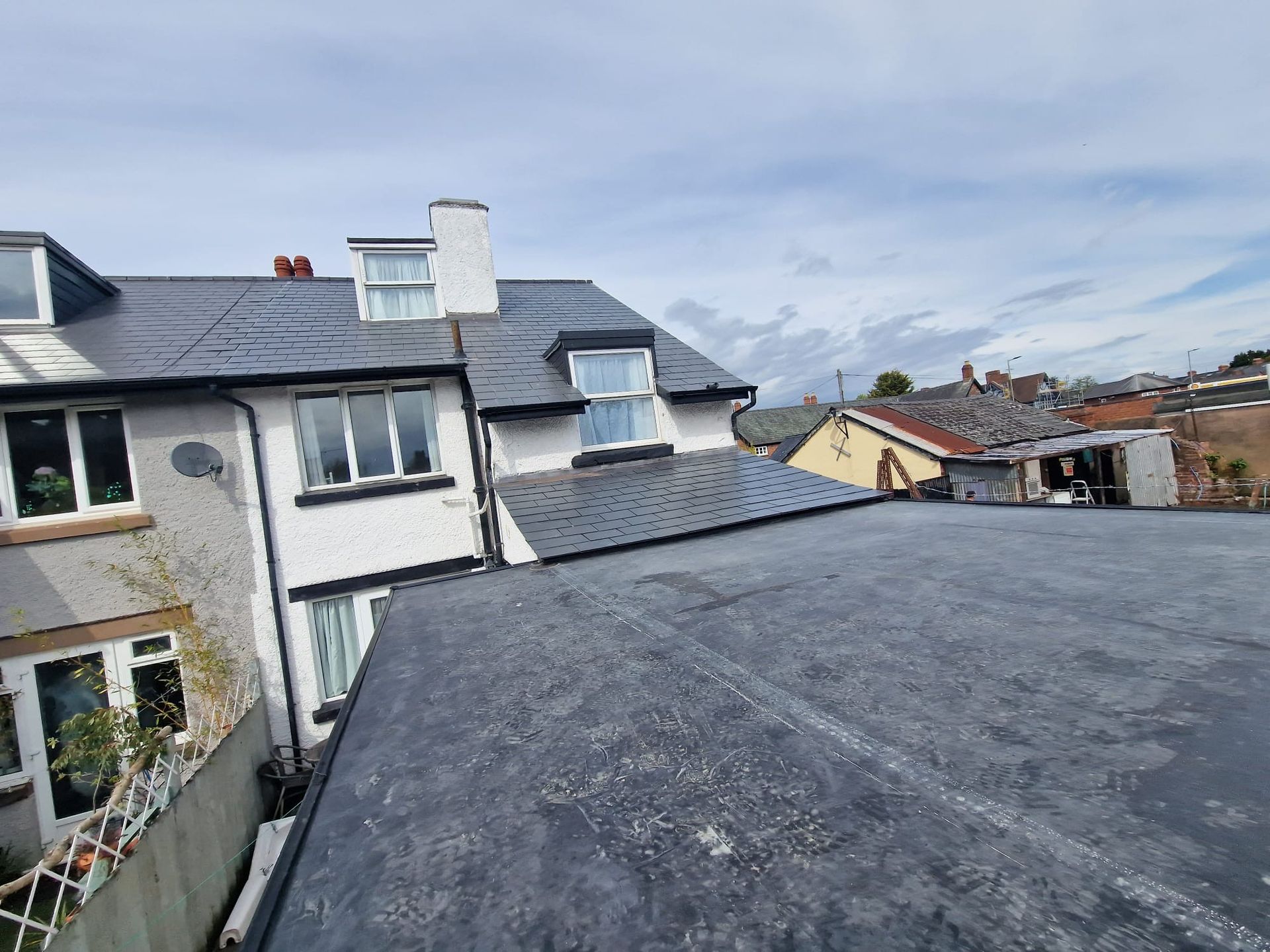 A rooftop view of a house with a slate roof