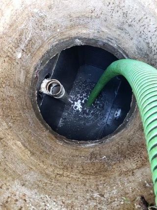 Man Pumping Out Grease — Santa Rosa, CA — Quality Septic Service Man Pumping Out Grease — Santa Rosa, CA — Quality Septic Service