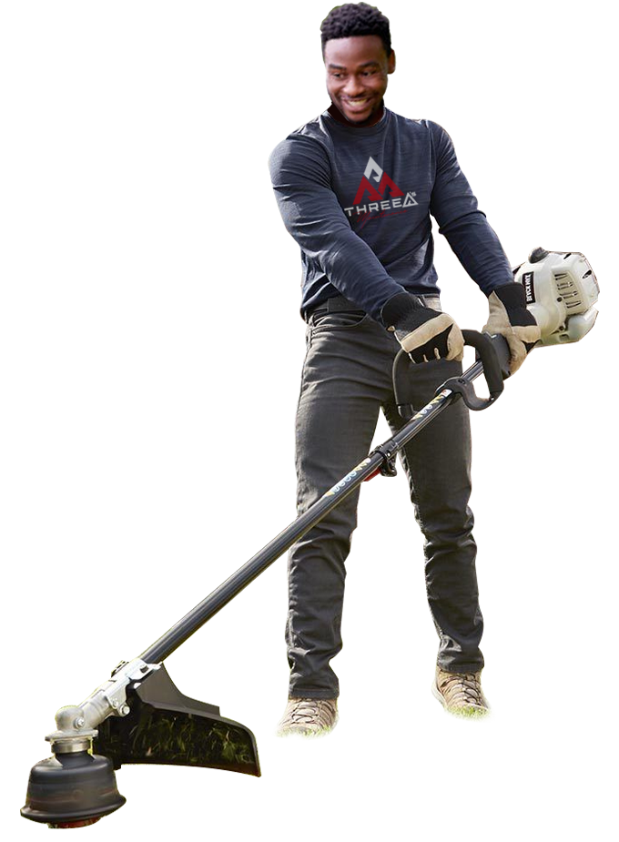 Man holding a string trimmer, smiling, outdoors.