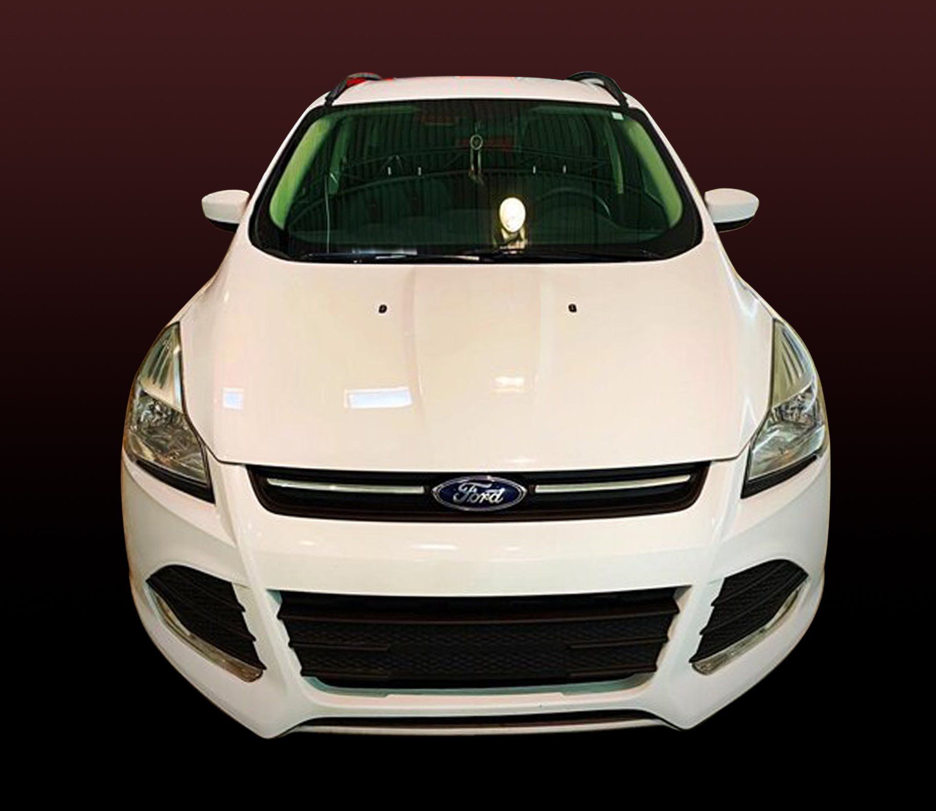 White Ford SUV, frontal view, black grill, dark background.