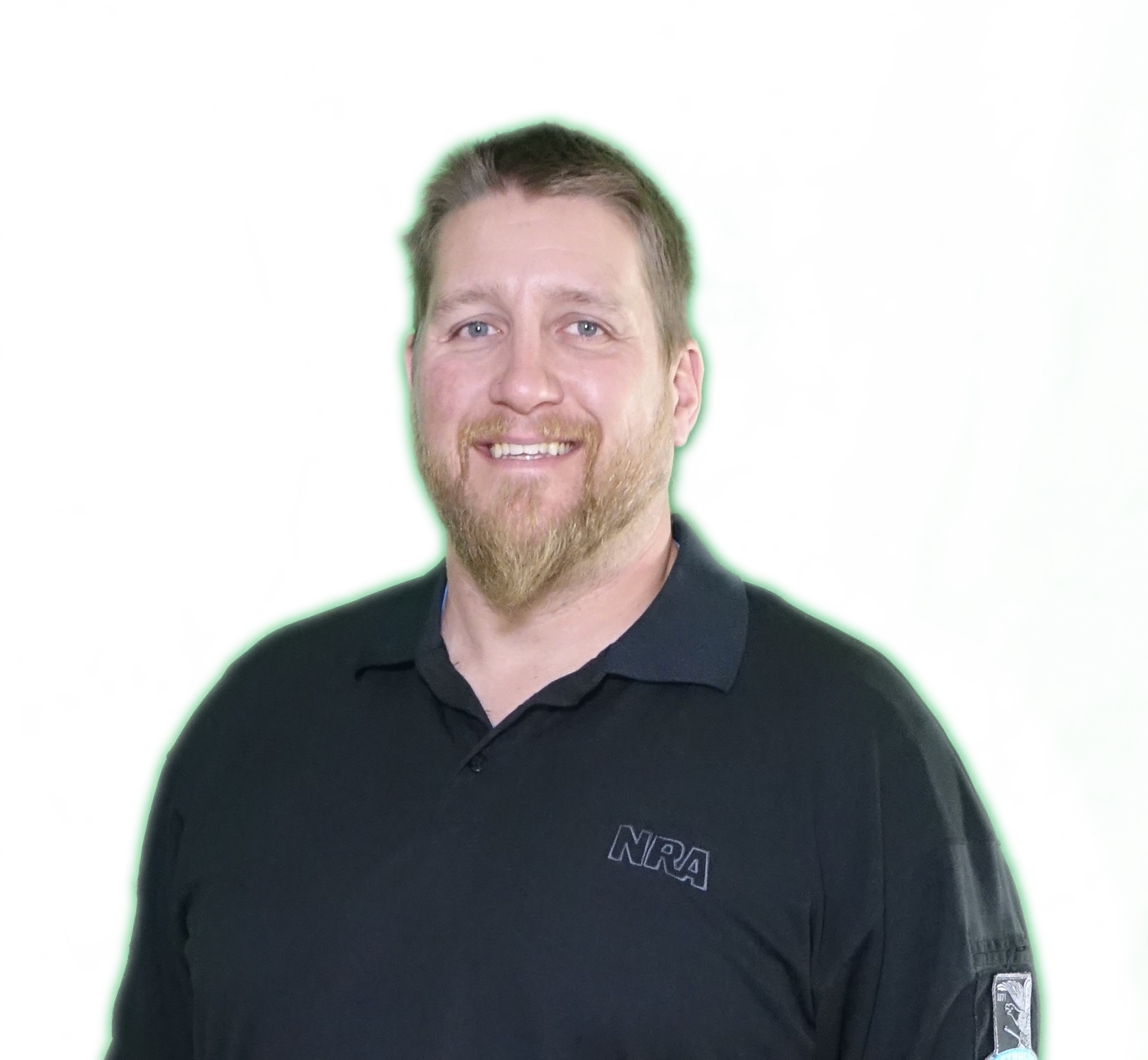 Smiling man in a black polo shirt against a white background