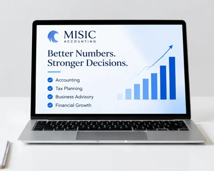 Laptop displaying a business growth chart on a clean white desk with a pen holder and notebook