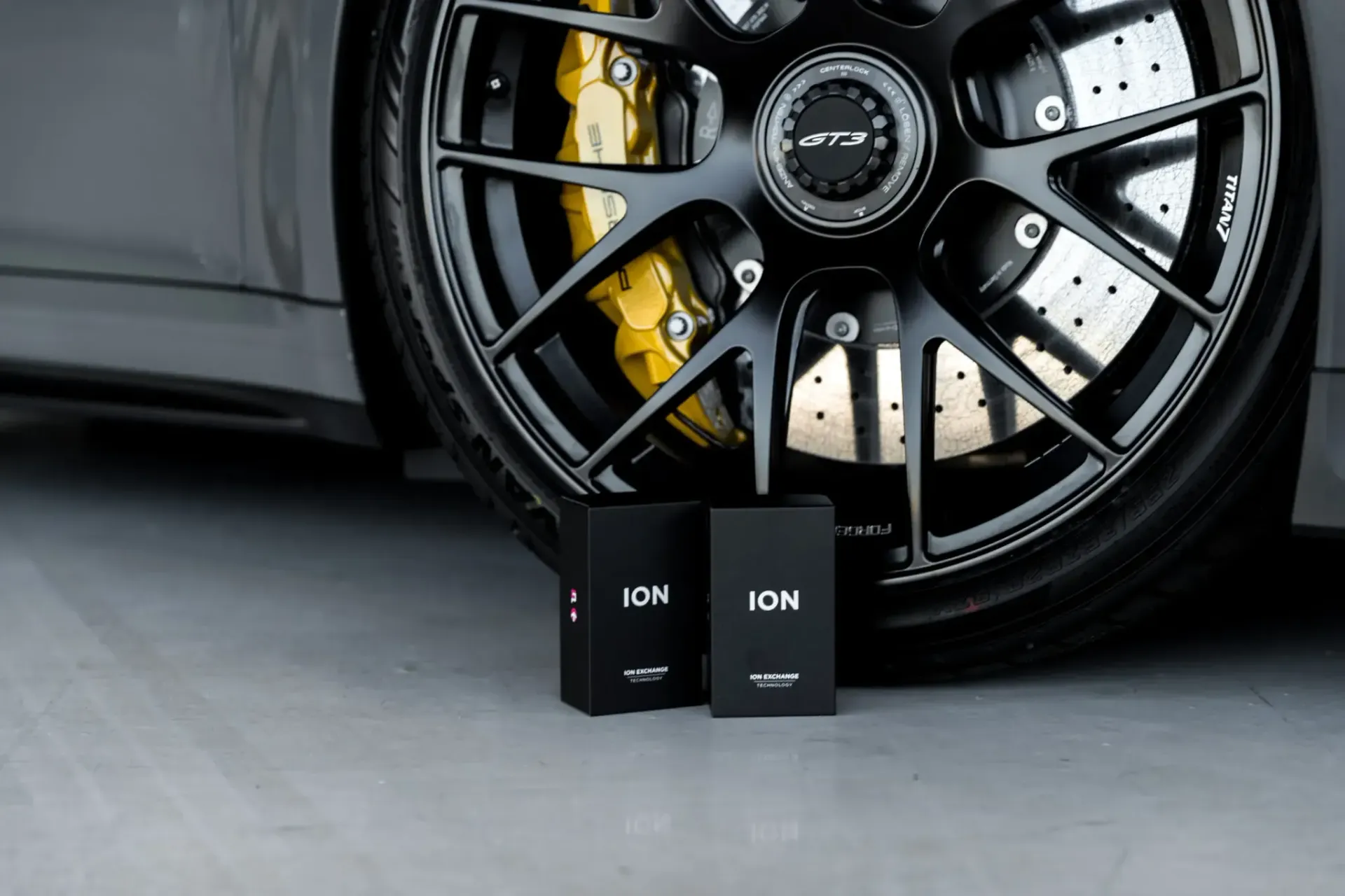 A close up of a car wheel with two boxes on it