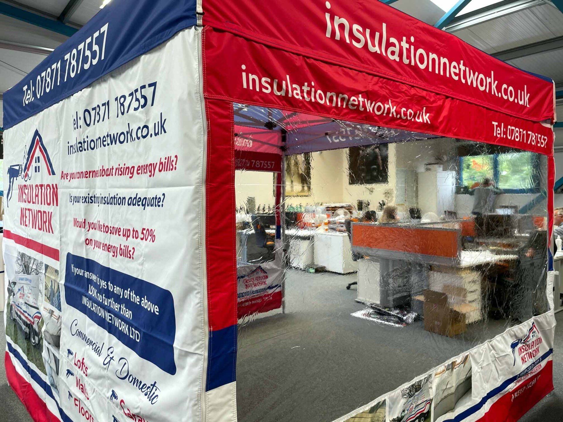 A red and white tent with insulation network written on it