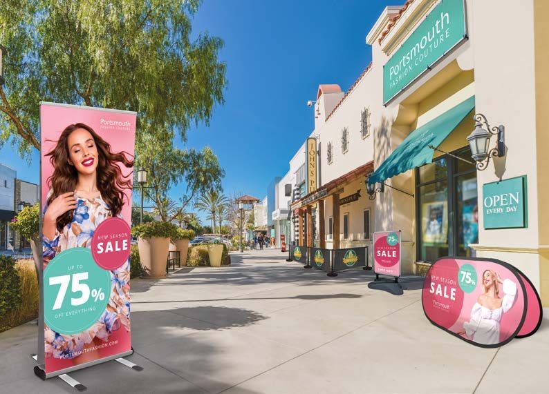 N3 Display Graphics | A woman is standing in front of a store with a sign that says 75 % sale.
