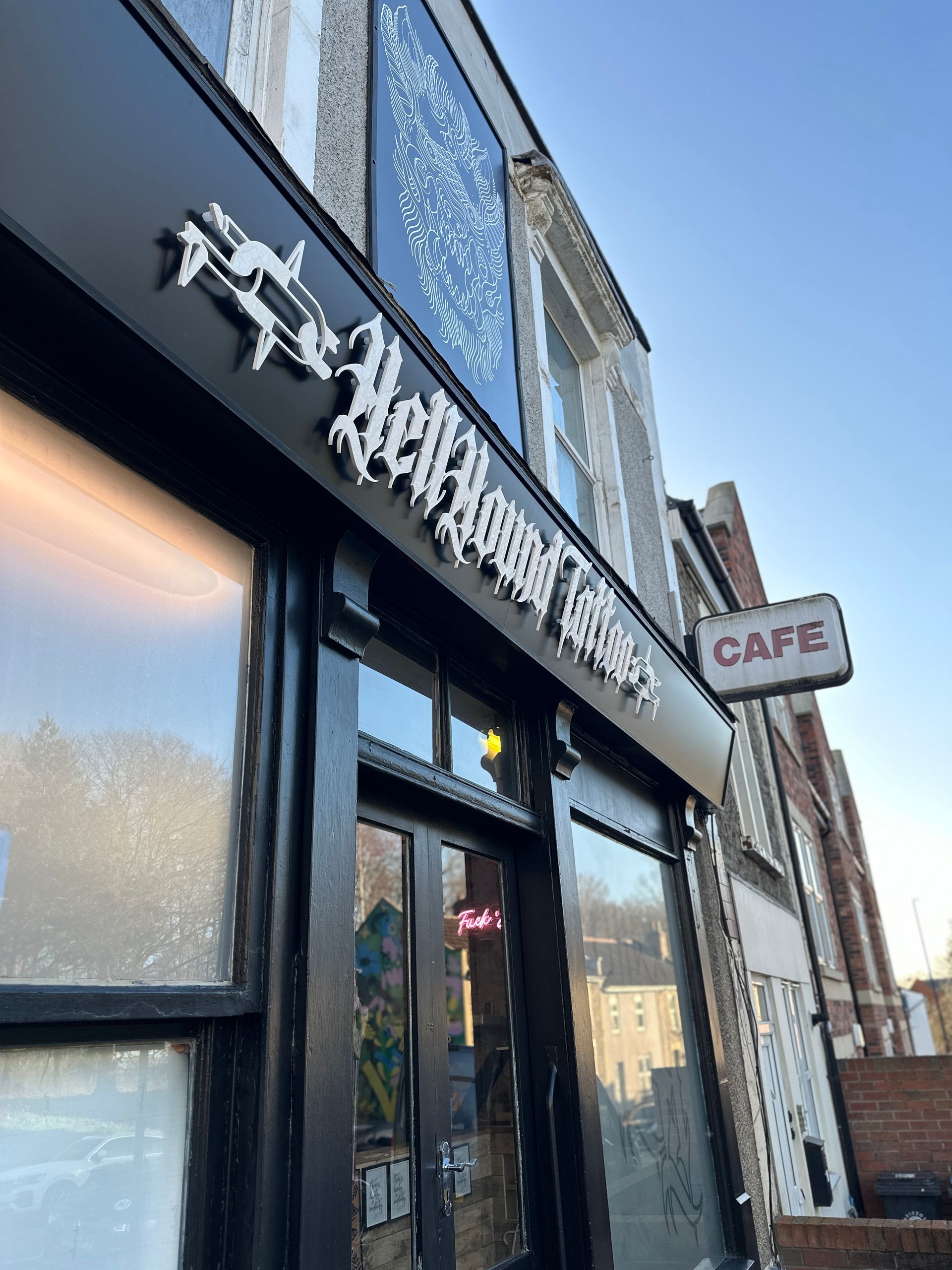 A black building with a sign that says cafe on it.
